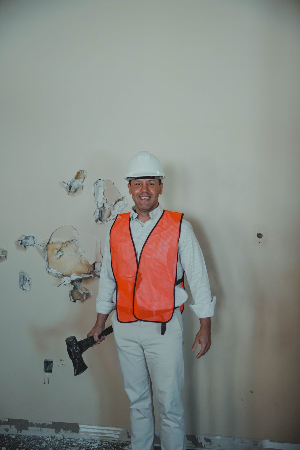 Pastor Edgar smiling with hammer